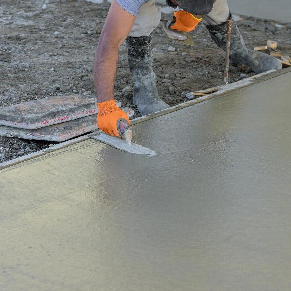 Construction worker smoothing concrete in Bromley